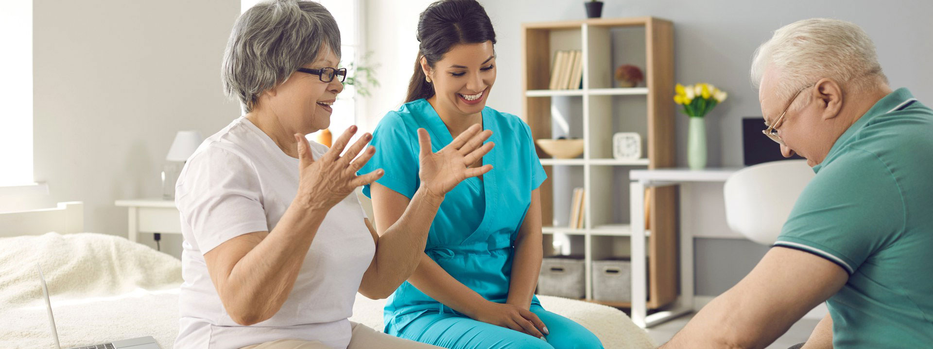 A caregiver sharing a warm moment with older adults at home